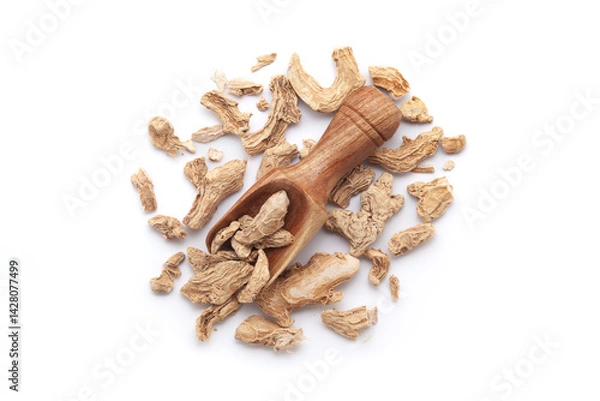 Fototapeta A wooden scoop filled with organic dry Ginger root (Zingiber officinale) or sonth, placed on a heap of ginger roots, isolated on a white background.