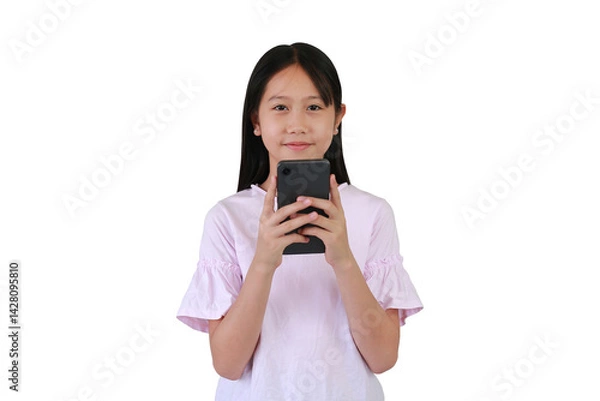 Fototapeta Asian pretty girl using smartphone on white background. Childhood and technology concept. Portrait of happy child using cell phone while looking camera.