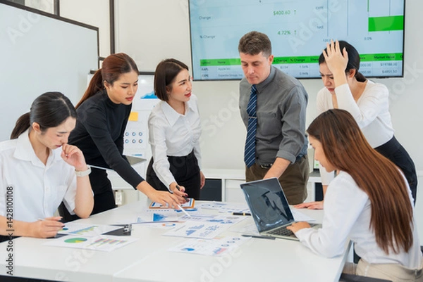 Fototapeta Group of business people are having a meeting and looking stressed about the work they are trying to solve.
