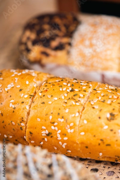 Obraz Soft Brownish Bread With Filling Sprinkled With Sesame Seeds. Looks Very Aesthetic And Appetizing.