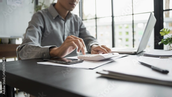 Obraz Business man accountant financial analyst and auditor working and laptop for calculating 