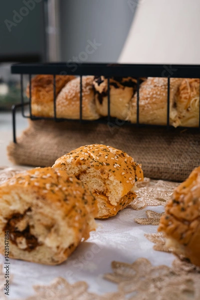 Obraz Soft Brownish Bread With Filling Sprinkled With Sesame Seeds. Looks Very Aesthetic And Appetizing.