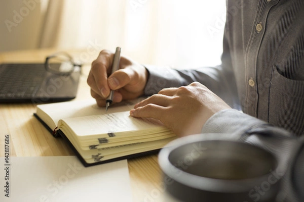 Obraz 机の上で仕事・勉強をする男性