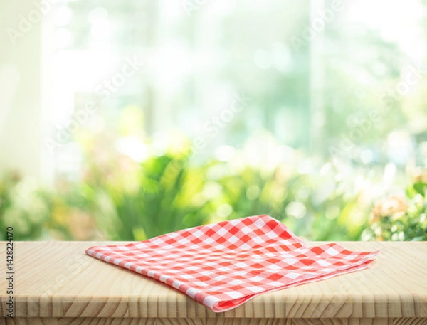 Fototapeta Fabric cloth or placemat on wood table top on blur kitchen room background.For montage product display