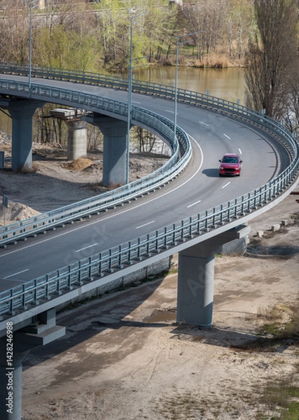 Fototapeta Red car driving on overpass, aerial view