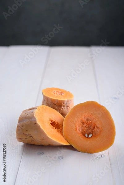Fototapeta Pumpkin pieces on white table
