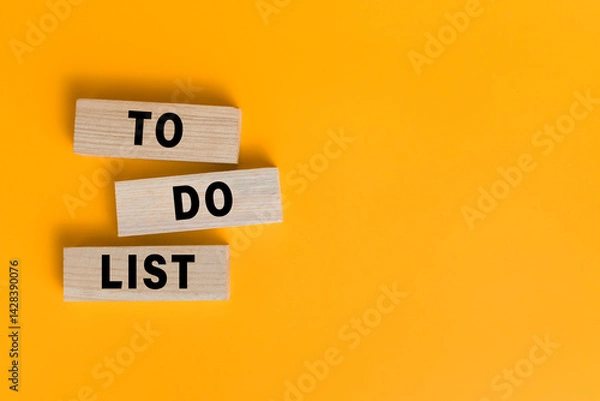 Fototapeta to do list words text on wooden blocks isolated on orange background. copy space
