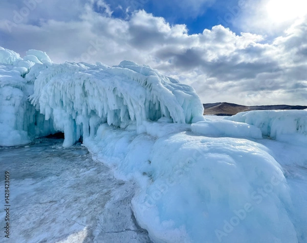 Fototapeta A large ice formation with a blue sky in the background