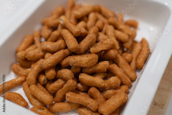 Obraz Crispy Savory Snacks in White Square Plate, Perfect for Relaxing Moments