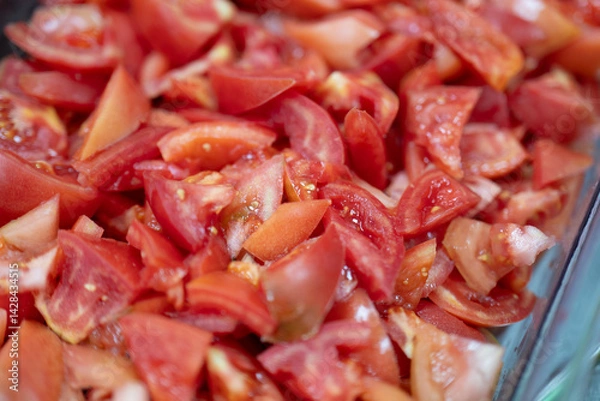 Obraz Fresh Chopped Tomato Pieces in Clear Container Ready for Cooking or Salad