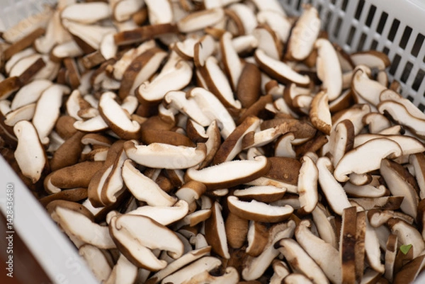 Obraz Sliced Shiitake Mushrooms in White Plastic Basket Showing Fresh Texture
