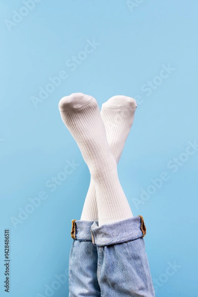 Fototapeta Bright white socks displayed against a vibrant blue background for retail promotion