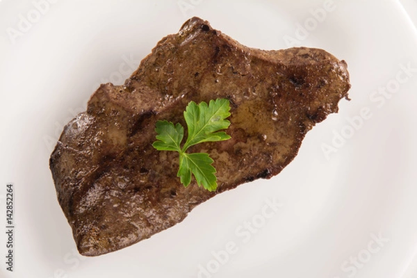 Obraz High angle view of a veal liver steack on a white plate