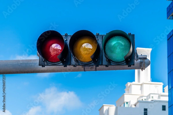 Obraz A view of a green illuminated traffic light above Collins Avenue in South Beach in Miami in springtime