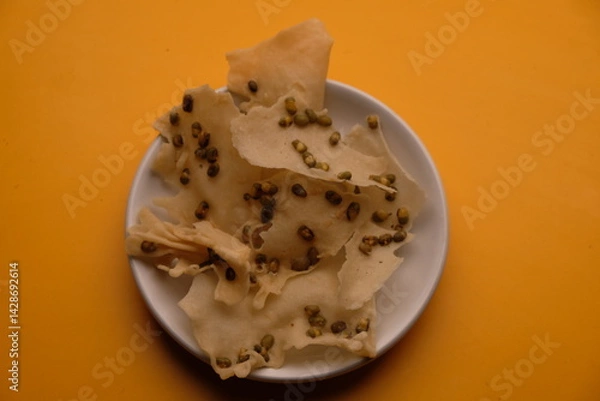 Fototapeta Rempeyek or Peyek is a snack or side dish made from flour with beans, shrimp, green beans, etc., fried in a flat shape. Rempeyek.kacang hijau. Indonesian food