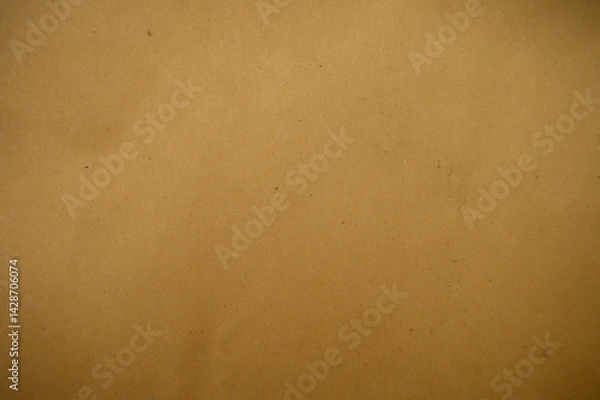 Fototapeta A close-up of a textured brown paper surface, showcasing its natural imperfections and warm, earthy tones, ideal for backgrounds or artistic designs