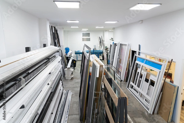 Fototapeta Aluminum and pvc window frames stockpiled in a carpenter's workshop