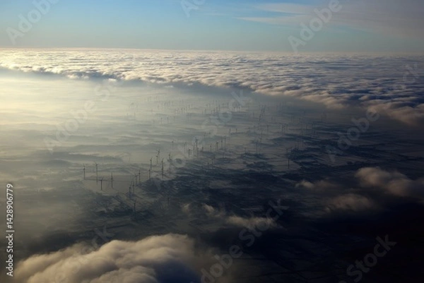 Obraz Aerial view of wind farm through clouds