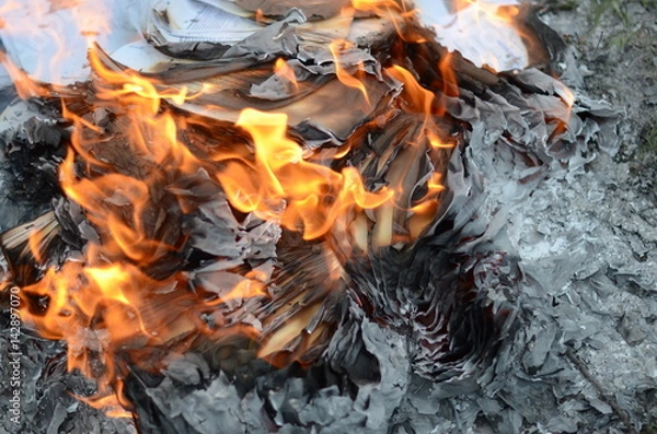Fototapeta Abstract background of a paper in fire