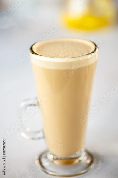 Obraz Coffee with milk, or Raw coffee in a tall glass.