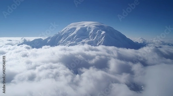 Fototapeta Majestic Snow Capped Mountain Peak Above Clouds