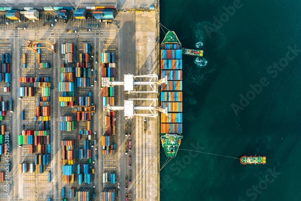 Obraz 123456Next
Top view of a large cargo ship loading and unloading containers at a deep-sea port. This aerial scene highlights global logistics, international trade, and maritime transportation hubs.