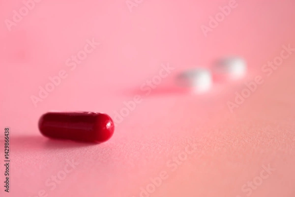 Fototapeta Pills on a pink background. Medications on a neutral background. Free space for writing.