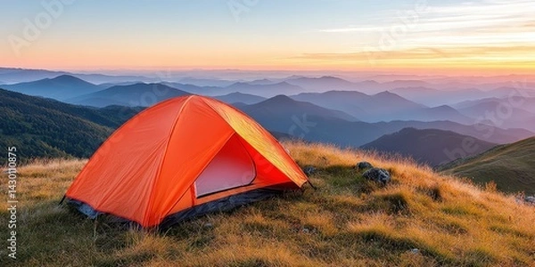 Obraz Vibrant Orange Tent Pitched on a Hilltop Under a Stunning Sunset Sky with Rolling Mountains in the Background