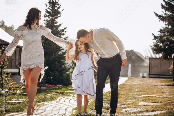 Obraz Family mother, father and daughter are beautiful and happy together, in white clothes, on a walk