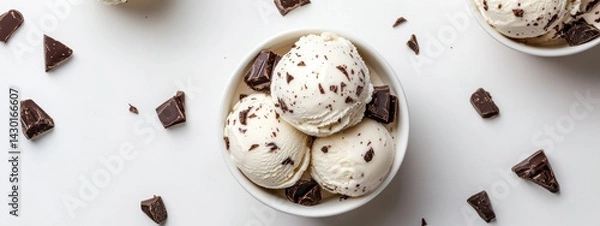 Obraz A bowl of vanilla ice cream with chocolate flakes and chunks, ideal for dessert lovers.