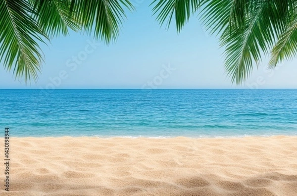 Fototapeta Scenic beach view with palm trees and ocean waves on a sunny day under a clear blue sky