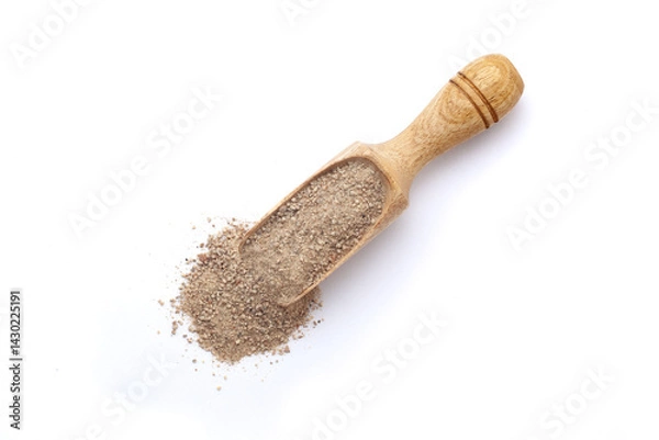 Obraz Top view of a wooden scoop filled with Organic White Pepper (Piper nigrum) powder. Isolated on a white background.