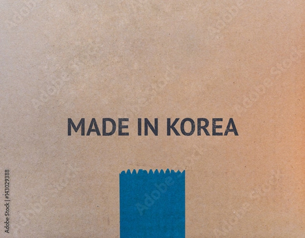 Fototapeta MADE IN KOREA written on brown cardboard box with copy-space for your text.