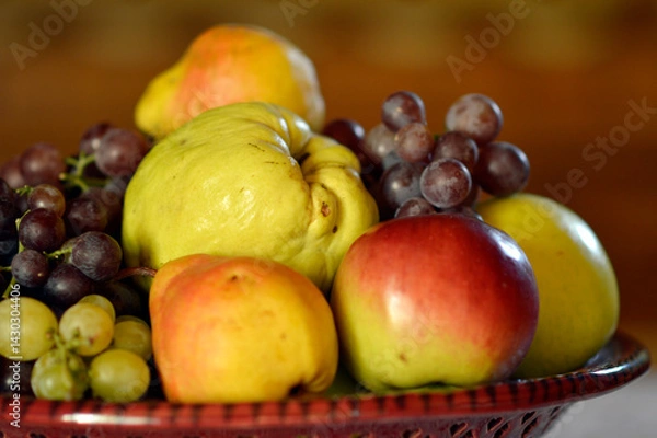 Fototapeta ceramic bowl with various ripe fruits at the table