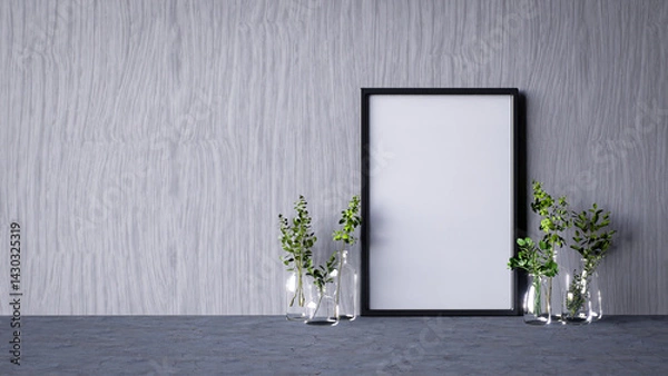 Fototapeta A minimalist setting featuring a blank frame against a textured wall, complemented by glass vases containing greenery.