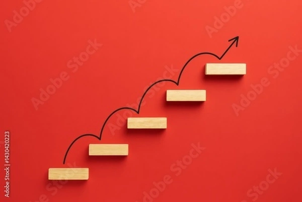 Fototapeta Climbing to Success: A visual representation of progress, with wooden blocks forming steps ascending against a striking red backdrop. A hand-drawn arrow illustrates the journey of growth and ambition