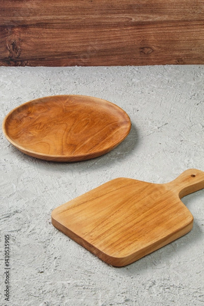 Obraz Empty Wooden Plate and Cutting Board on Concrete Table with Wooden Wall Background, Minimalist Kitchenware Flatlay for Food Mockup, Rustic Natural Cooking Scene with Copy Space