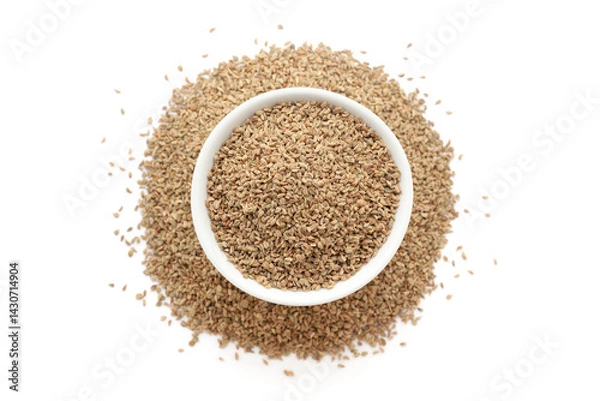 Obraz A bowl of Organic Carom seeds (Trachyspermum ammi) or Ajwain, placed over a heap of whole Carom seeds. Isolated on a white background.