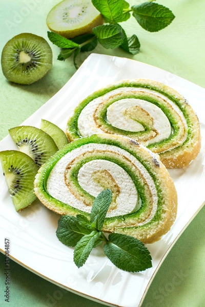 Fototapeta Cake roll with kiwi marmalade and marshmallow