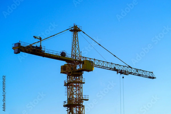 Fototapeta construction crane on the blue sky background