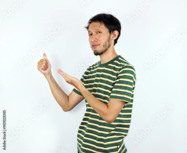 Fototapeta Man Presenting Something Showing Approval Against a Plain Background