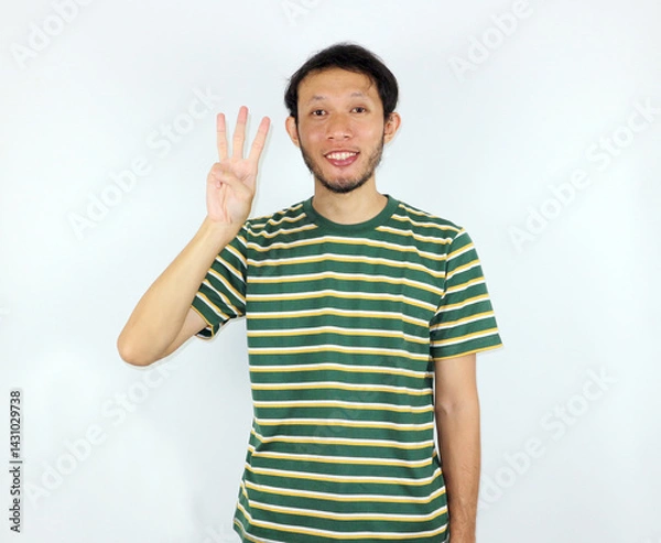 Fototapeta Person Showing Three Fingers in Studio with Striped Shirt Smiling