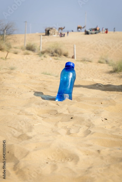 Fototapeta drinking water bottle kept at desert open heat at bright daylight
