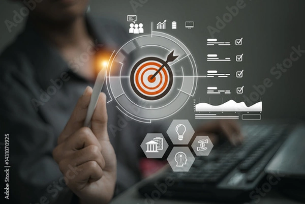 Obraz A hand holds a stylus pointed at a digital target surrounded by charts, checklists, and business icons, symbolizing focus and analytics..