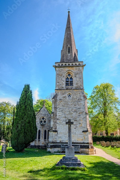 Obraz The Parish Church of Saint Mary in Lower Slaughter rises sharply against a rare clear blue sky, under the bold spring sunlight