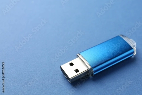 Obraz One flash drive on blue background, closeup. Space for text