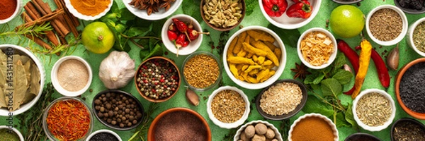 Fototapeta A beautiful collection of colorful spices and herbs, showcasing their natural aromas and vibrant hues on a gentle green background, banner