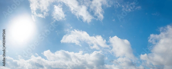 Fototapeta sky background with light shine from sun at the left and fluffy clouds