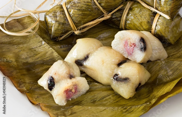 Obraz Sticky rice stuffed with bananas and black bean wrap with banana leaf thai dessert (Thai name  Kao Tom Mud)
