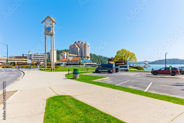 Fototapeta The landmark downtown clock tower, resort and marina at Independence Point, on the lake in Coeur d'Alene, Idaho USA at early Spring.
